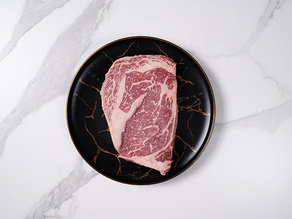 American Waguy Ribeye MS 10 16oz top view on marble background