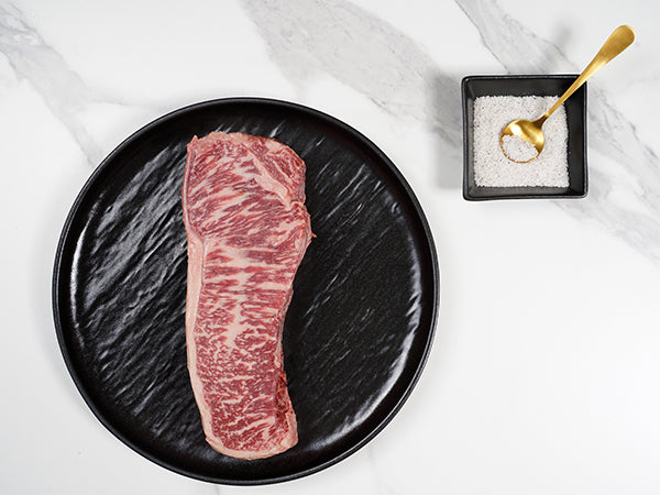 Australian Wagyu New York Strip MS 12 - 13-14oz or 20oz top view with salt - Halal Wagyu New York Strip